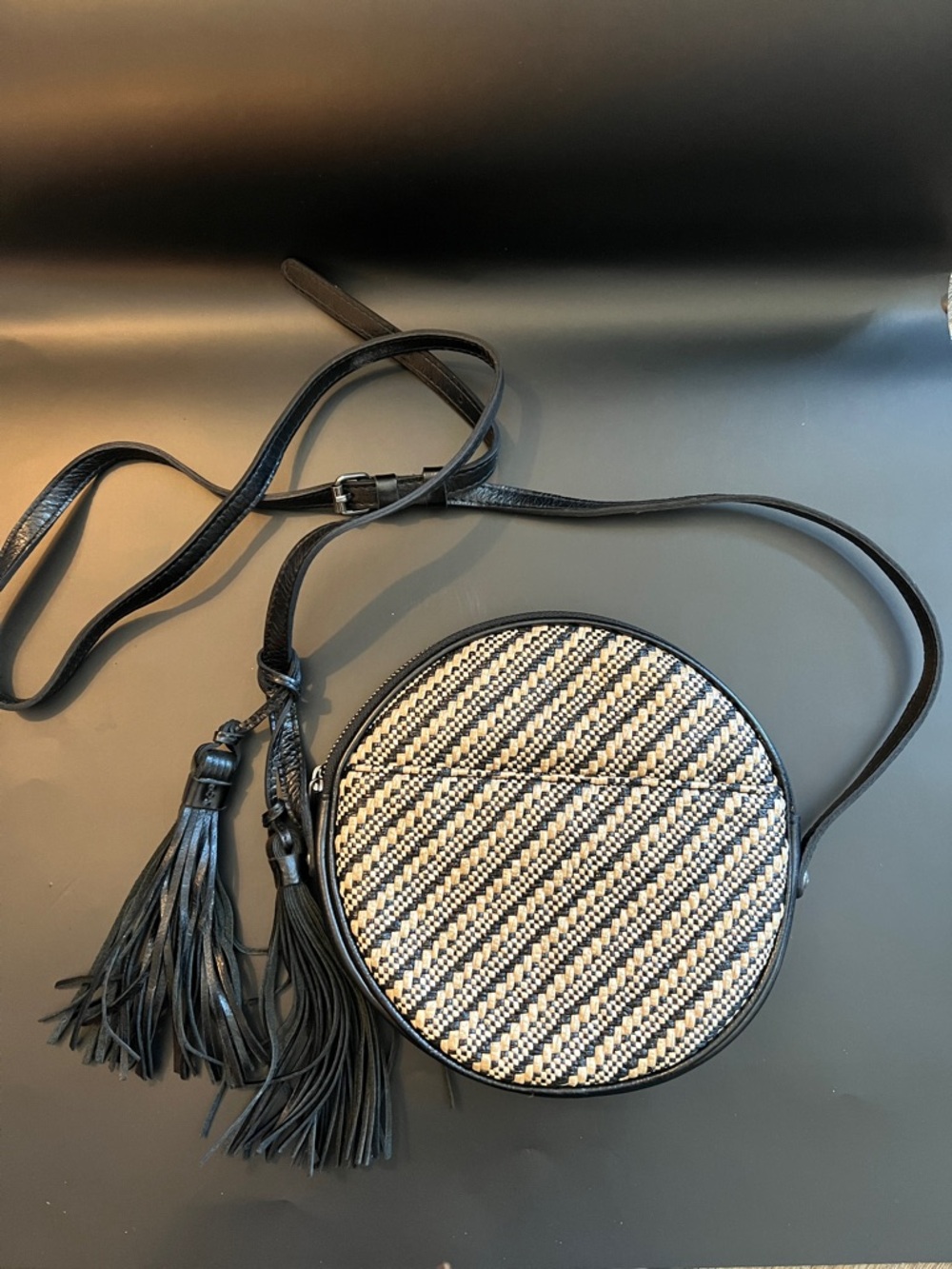Patricia Nash Black and Cream Woven Round Crossbody with Tassels